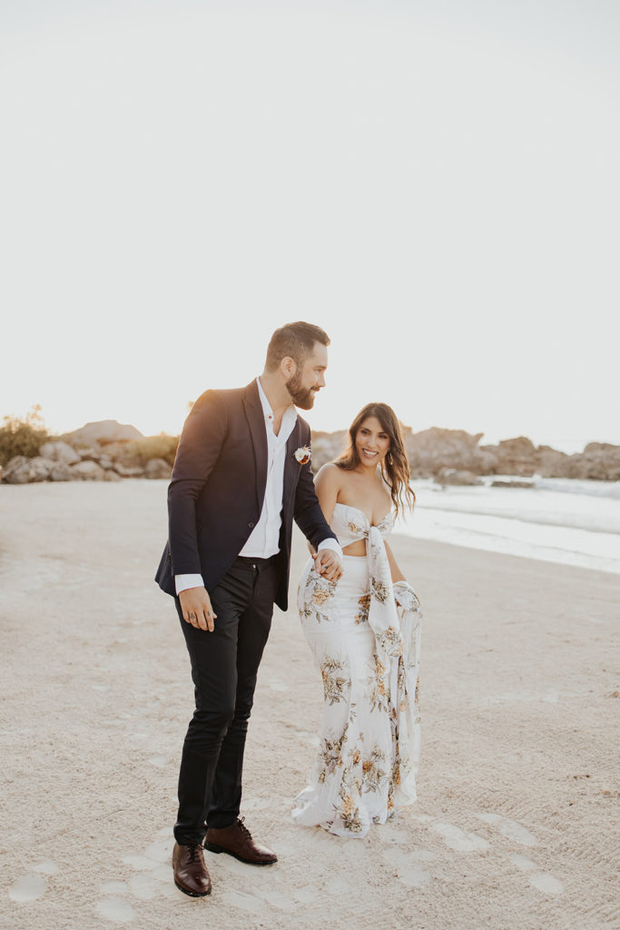 walking on the beach to a sunrise elopement in Tulum Mexico