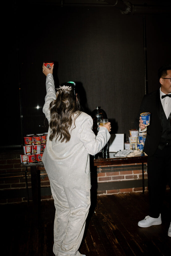 bride and groom posing in front of their ramen bar, flash wedding photography