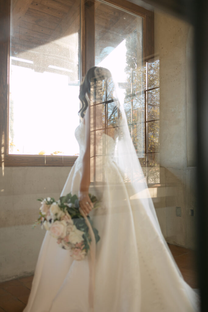double exposure wedding photo of bride holding flower bouquet and walking down hall