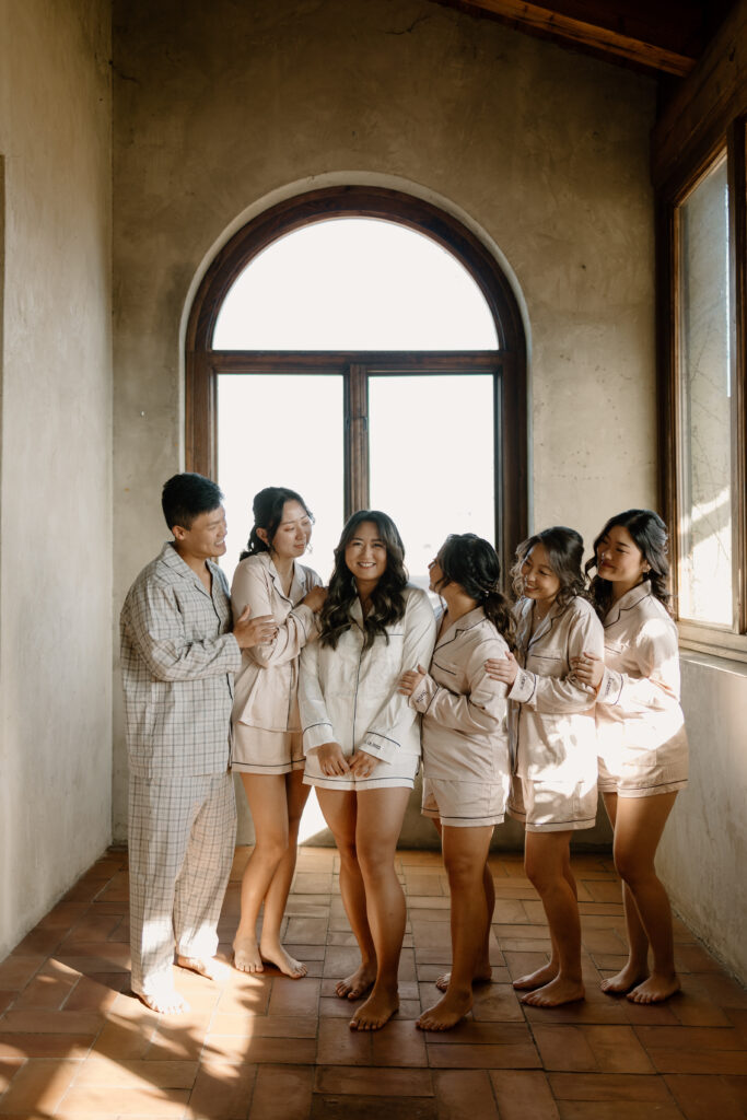 bridesmaids in pajamas while looking at bride 