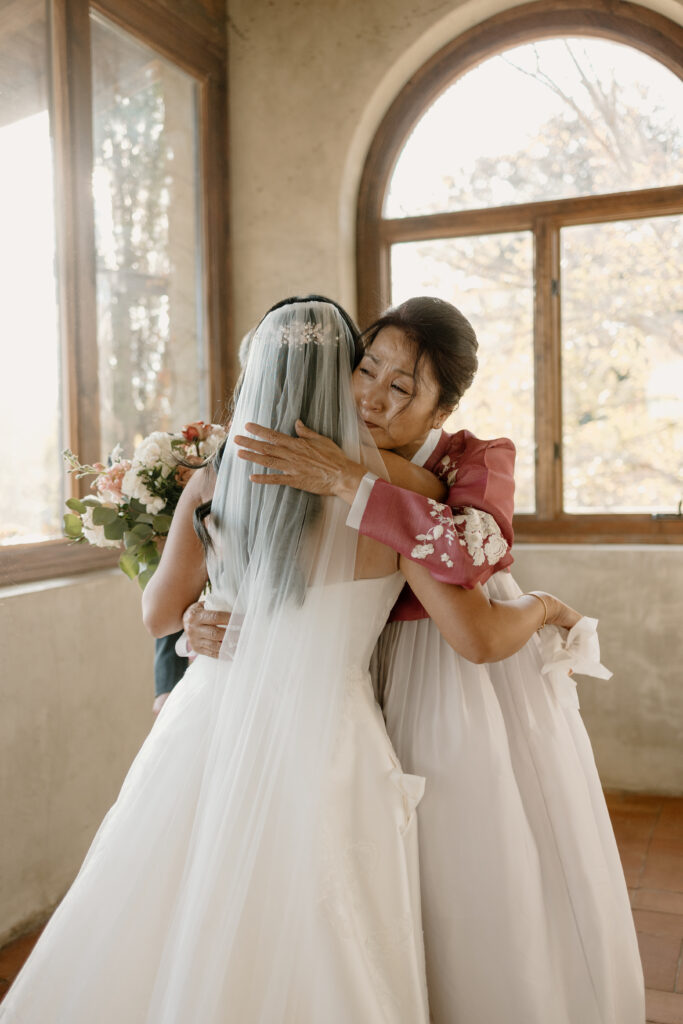 mother hugging daughter who is getting married 