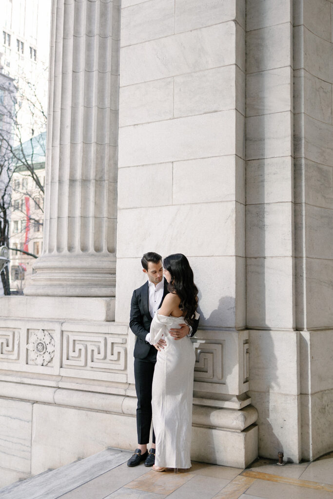 couple looking at each other during their engagement photos at the New York City public library