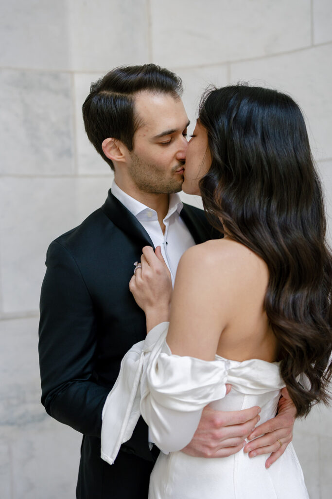 man and woman kissing each other while posing for engagement photos