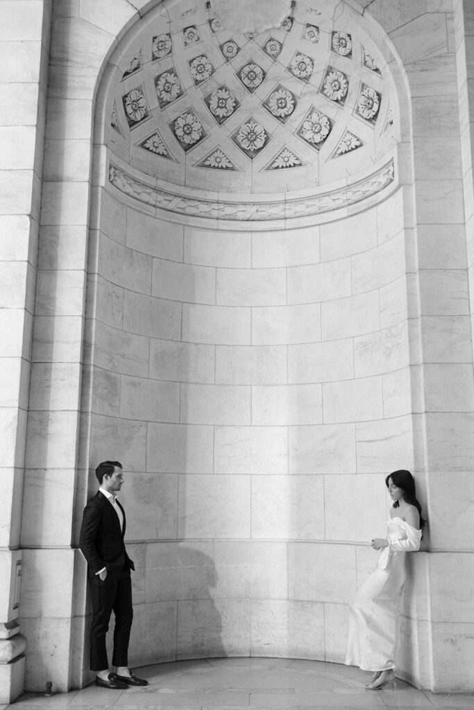 man and woman standing across from each other for their engagement photos